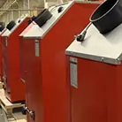 Zdjęcie prezentujące piece centralnego ogrzewania 5 klasy Stalmark ustawione w rzędzie